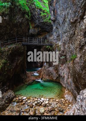 Metal Hiking Bridge Over an Emerald Green Pool in the Deep Almbachklamm Canyon, Germany Stock Photo