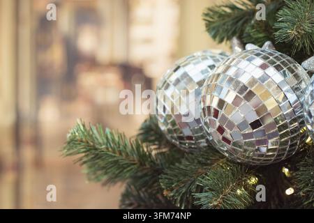 Christmas tree with holiday silver balls and lights on blurred bokeh background. Stock Photo