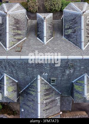 Slate roof tiles viewed from above for condition check Stock Photo