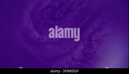 Defocused glitter paint. Purple splash pigment. Vibrant blue color bright texture water particles fluid spill on abstract art background. Stock Photo
