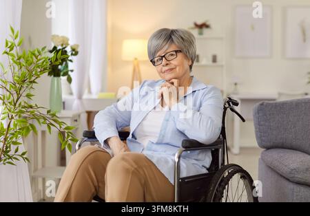 Old senior woman handicapped old lady patient sitting in wheelchair, female disabled grandma Stock Photo