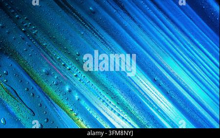 Abstract background showing blue and green diagonal lines with many small water drops on a reflective wet surface Stock Photo
