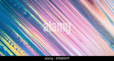 Abstract textured background showing liquid paint flowing in diagonal stripes with vibrant iridescent colors, bubbles, and glowing effects Stock Photo