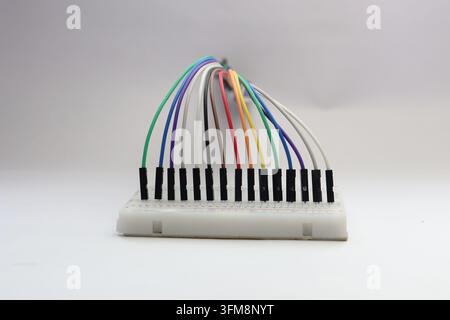 Neatly arranged jumper wires connected to a breadboard close up view Stock Photo