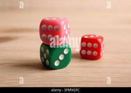 Risk management and decision making colorful dice stacked on a wooden table strategy chance and business opportunity in a corporate setting Stock Photo