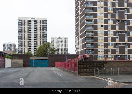 De Beauvoir Estate housing towers in Hackney, East London, viewed from a car park with residential tower blocks and communal playground. Stock Photo