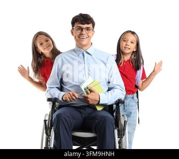 Inclusive education and disability awareness, male teacher in wheelchair with diverse school children in classroom setting on white background Stock Photo