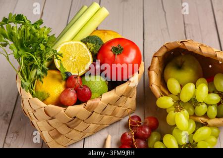Healthy nutrition and clean eating, fresh organic vegetables and fruits in woven baskets on rustic wooden table for balanced diet and wellness lifesty Stock Photo