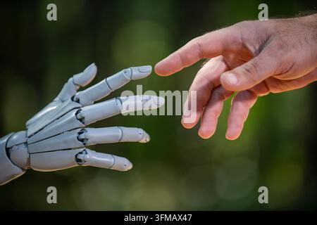 Robot human handshake ecology eco. Robot human handshake green environment. Robot human handshake care protection. Robot human handshake nature connec Stock Photo