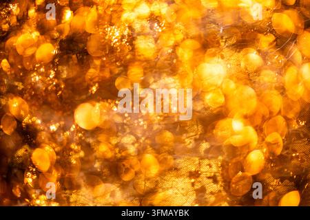 Golden luxury wallpaper in shimmering gloss. Golden shiny gold flakes on metallic surface. Golden abstract art for branding. Golden sparkling Stock Photo