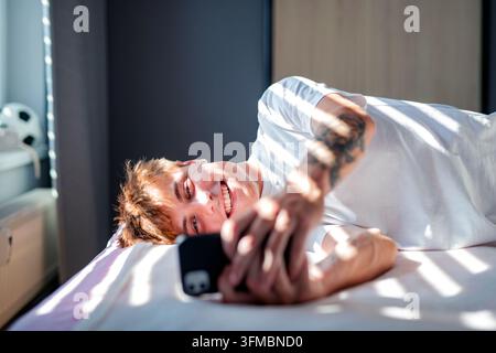 Man in love texting to his partner. Stock Photo