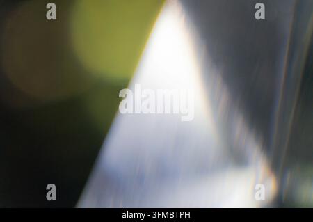 This abstract texture background features a prominent diagonal band of cool-toned gradient light, transitioning from white to blues and purples, creat Stock Photo