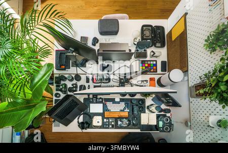 Home Studio creator workspace desk camera drone setup. High angle overhead view of a modern content creator desktop workstation featuring digital came Stock Photo
