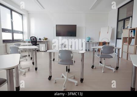 Empty modern primary school classroom ready for students. Stock Photo
