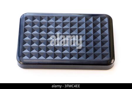 A dark portable data storage unit sits isolated on white Stock Photo