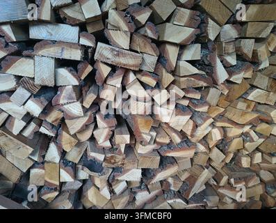 Stacked chopped firewood logs creating natural rustic wooden background texture Stock Photo