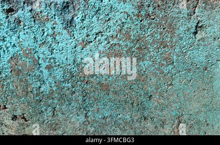 Rough concrete wall with remnants of blue paint. Stock Photo
