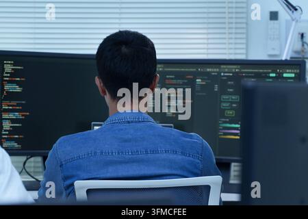 Programmer Developing Digital Software and AI Code Stock Photo
