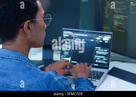 Programmer Coding Software on Laptop Stock Photo