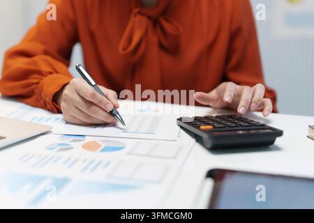 Businesswoman Calculating Financial Data and Reviewing Documents Stock Photo