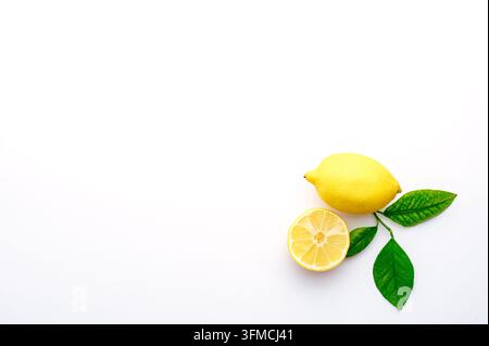 Fresh whole lemon and a half on white background Stock Photo