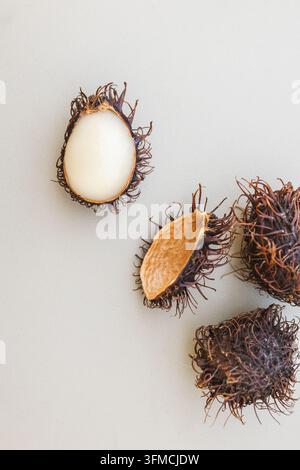 Dried rambutan exotic fruits on a neutral background Stock Photo
