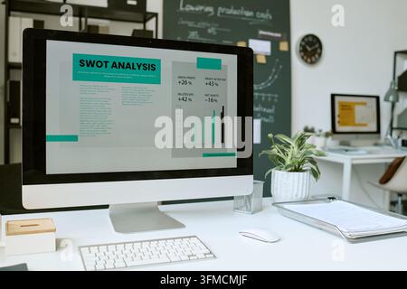Computer Monitor Displaying SWOT Analysis Report in Modern Office Stock Photo