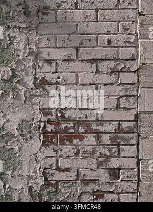 Weathered light pink multi-material wall with central chipped red clay brick in running bond, exposed porous concrete, grooved cinder blocks Stock Photo
