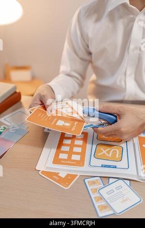 Close-up of a UX designer arranging wireframes and interface components while planning a digital product. Creative workflow for user experience, proto Stock Photo