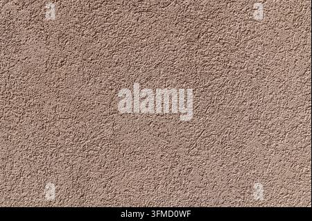 Textured stucco plaster wall displaying fine grain in neutral tone. Stock Photo