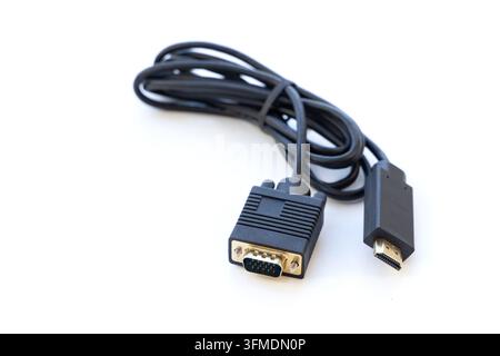 Black converter cable sits coiled on a white surface Stock Photo