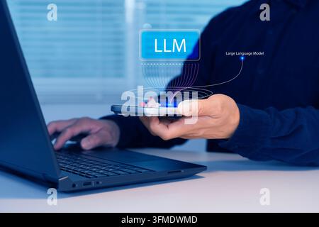Person holds tablet with floating 'LLM' hologram above laptop. Hands steady, focused on digital interface. Suggests AI technology, data analysis, or m Stock Photo