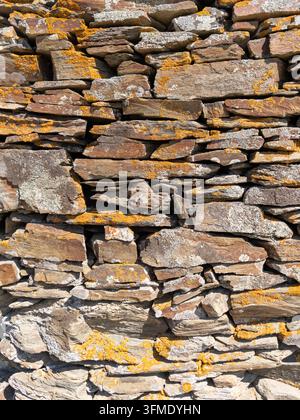 Close-up of a traditional dry stone wall showcasing weathered Mediterranean stonework in Portlligat near Cadaques, Catalonia, Spain. Stock Photo