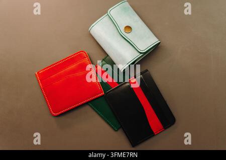 Colorful handmade leather wallets and card holders are arranged on a table. Product collection showcases artisan design, variety and craftsmanship Stock Photo