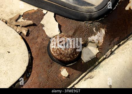 Close-up of a rusted metal fitting on a weathered vintage car Stock Photo