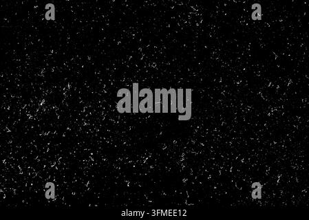 Horizontal view of dark monochrome surface with small shining dust grains pattern Stock Photo
