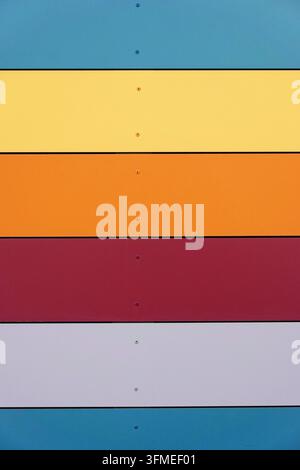 Multicolored wall paneling background with horizontal plates in blue gray red orange and yellow Stock Photo