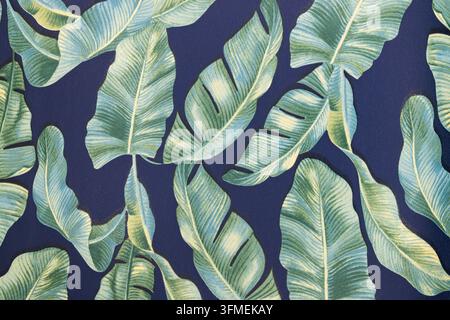 Lush green banana leaves frame traditional village rooftops against ...