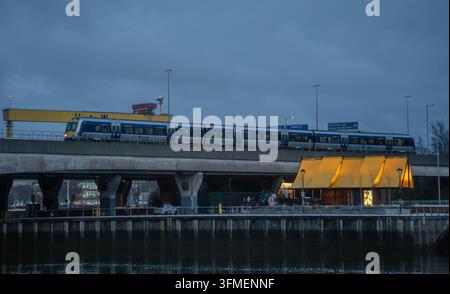 A Translink railway service passing next to the M3 on approach to York Street station Stock Photo