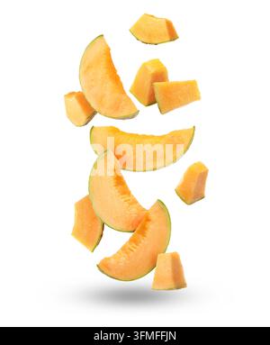 Pieces of cantaloupe melon falling on white background Stock Photo