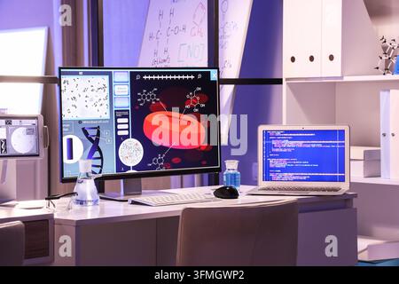 Biomedical research and medical innovation, laboratory workstation with computer displaying blood cell analysis and software code for scientific devel Stock Photo