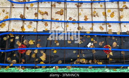 Underfloor heating pipes installed over reinforcement mesh at construction site Stock Photo