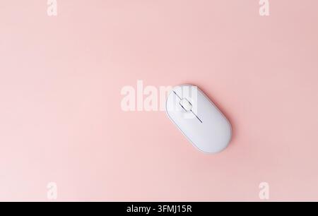 White computer mouse on pink background, top view Stock Photo