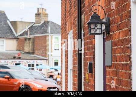 Outdoor wall lamp on the brick wall of a terraced cottage in Southwold, England Stock Photo