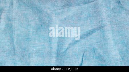 Light blue linen fabric background with subtle wrinkles and textured woven pattern for design Stock Photo