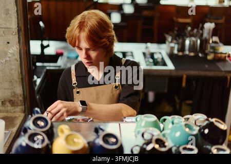 Male Barista Preparing Coffee with Machine in Modern Cafe Stock Photo