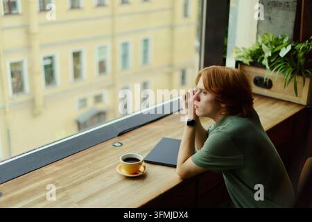 Thoughtful Man Looking through Window during Remote Work Break Stock Photo