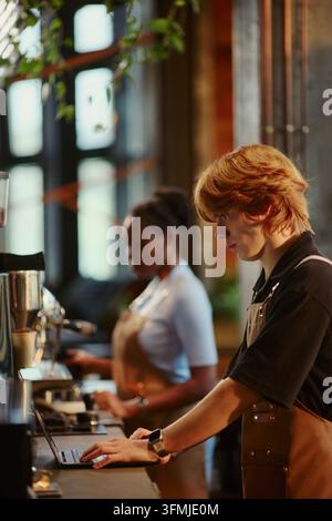 Barista Man Using Laptop While Working in Modern Coffee Shop Stock Photo