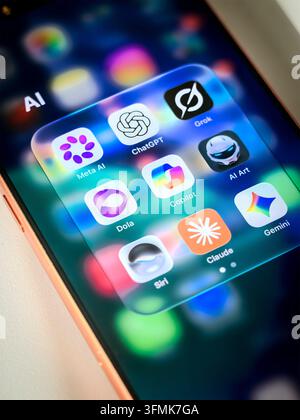 Smartphone screen with folder containing AI applications icons such as ChatGPT Meta AI Grok Copilot Claude Gemini Siri Stock Photo