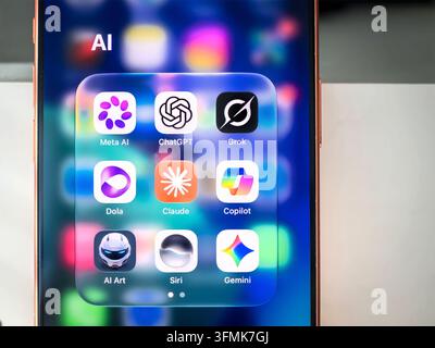 Smartphone screen with folder containing AI applications icons such as ChatGPT Meta AI Grok Copilot Claude Gemini Siri Stock Photo